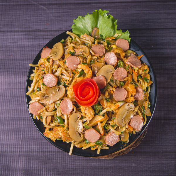 Chicken, mushroom, colorful vegetables, fried noodles tossed in savory sauce.